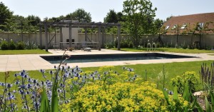 Swimming pool courtyard with pergola and flowers